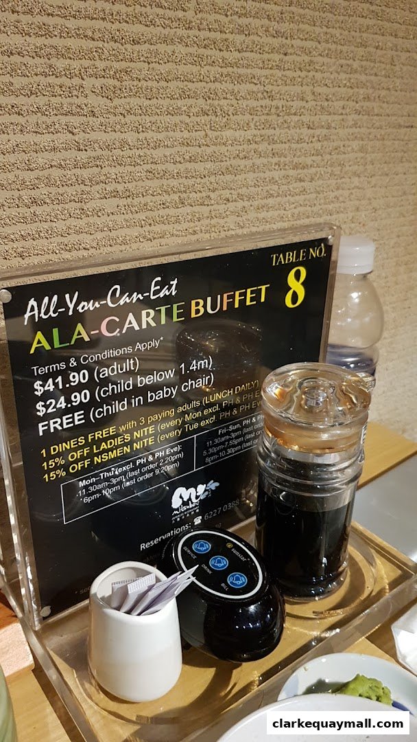 A sign detailing an all-you-can-eat a la carte buffet with prices and terms.