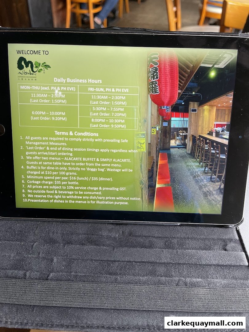 A tablet displaying the business hours and terms for Mitsuba Japanese Restaurant.