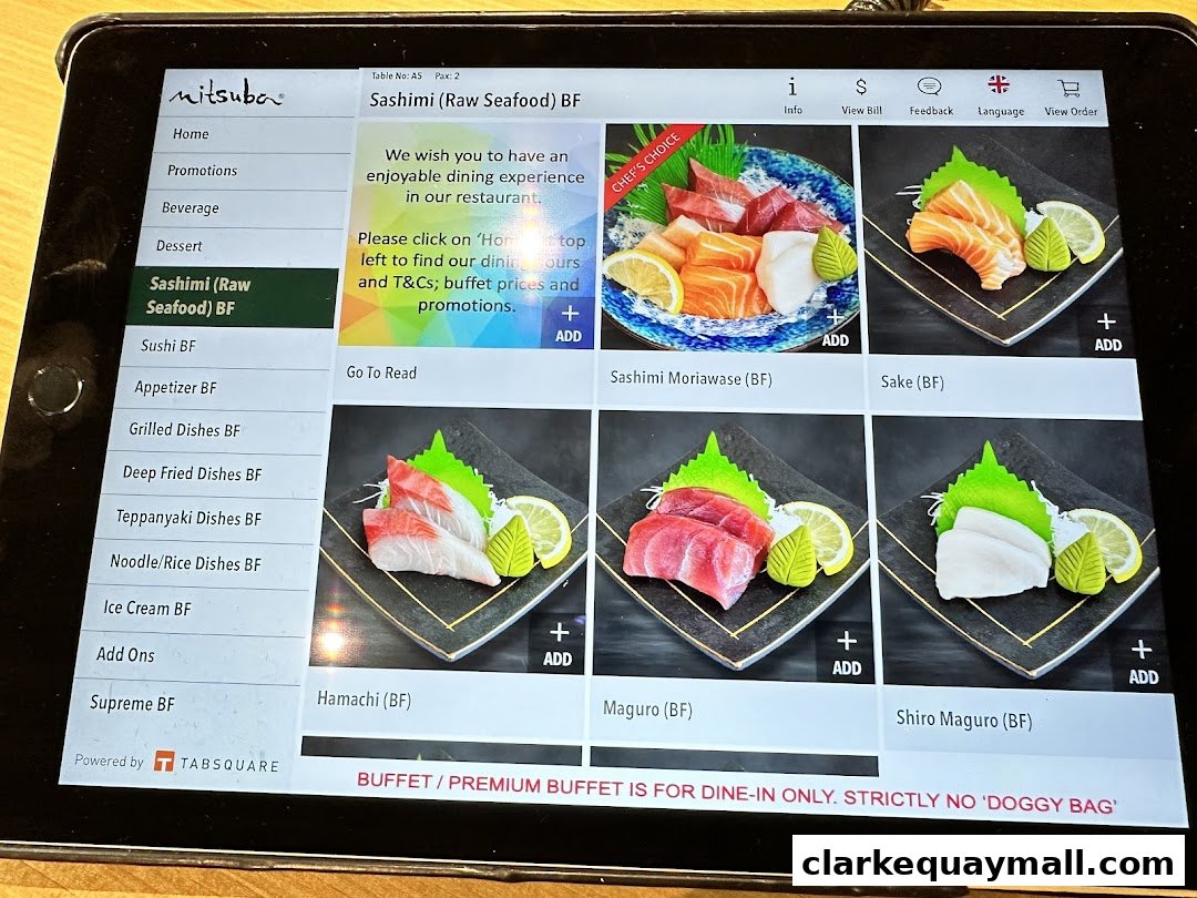 A tablet displaying the Mitsuba Japanese Restaurant's sashimi menu with various raw seafood options.