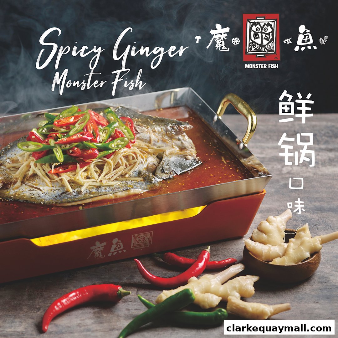 A steaming dish of fish with chili and ginger, presented in a red heating tray.