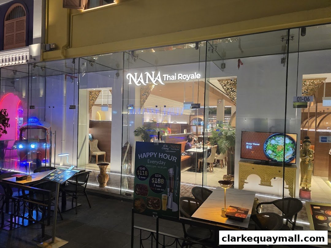 The exterior of Nana Thai Royale restaurant at night, with a tuk-tuk decoration and outdoor seating.