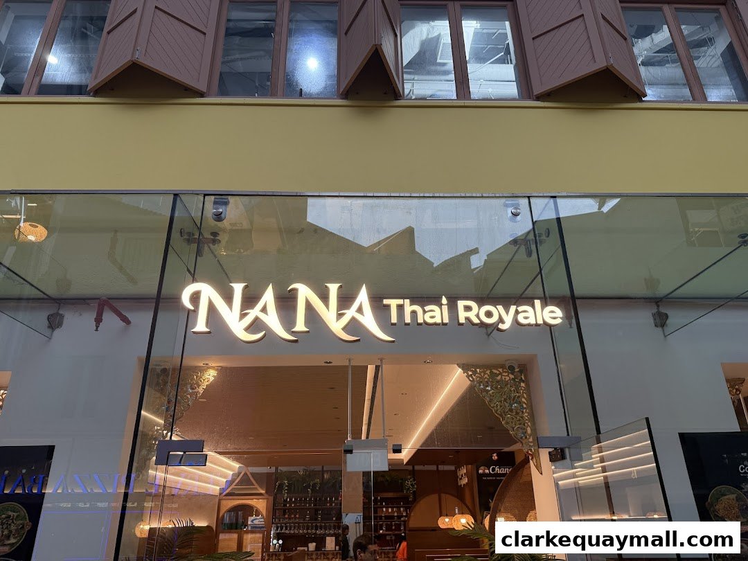 The illuminated sign for Nana Thai Royale is displayed on the glass facade of the restaurant.