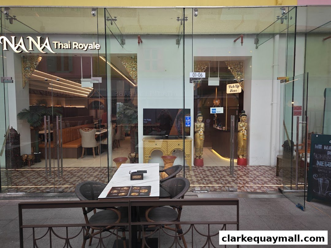 The exterior of Nana Thai Royale restaurant with a seating area outside.