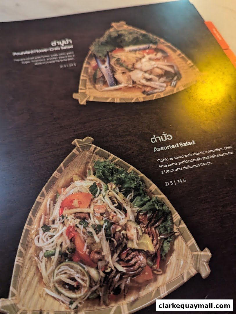 A menu page showcasing two Thai dishes with vibrant ingredients and appealing presentation.