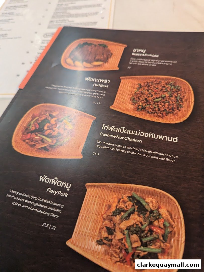 A menu from Nana Thai Royale Clarke Quay featuring Thai dishes with images and descriptions.