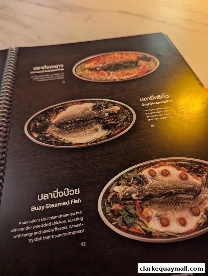 A menu page from Nana Thai Royale Clarke Quay featuring steamed fish dishes.