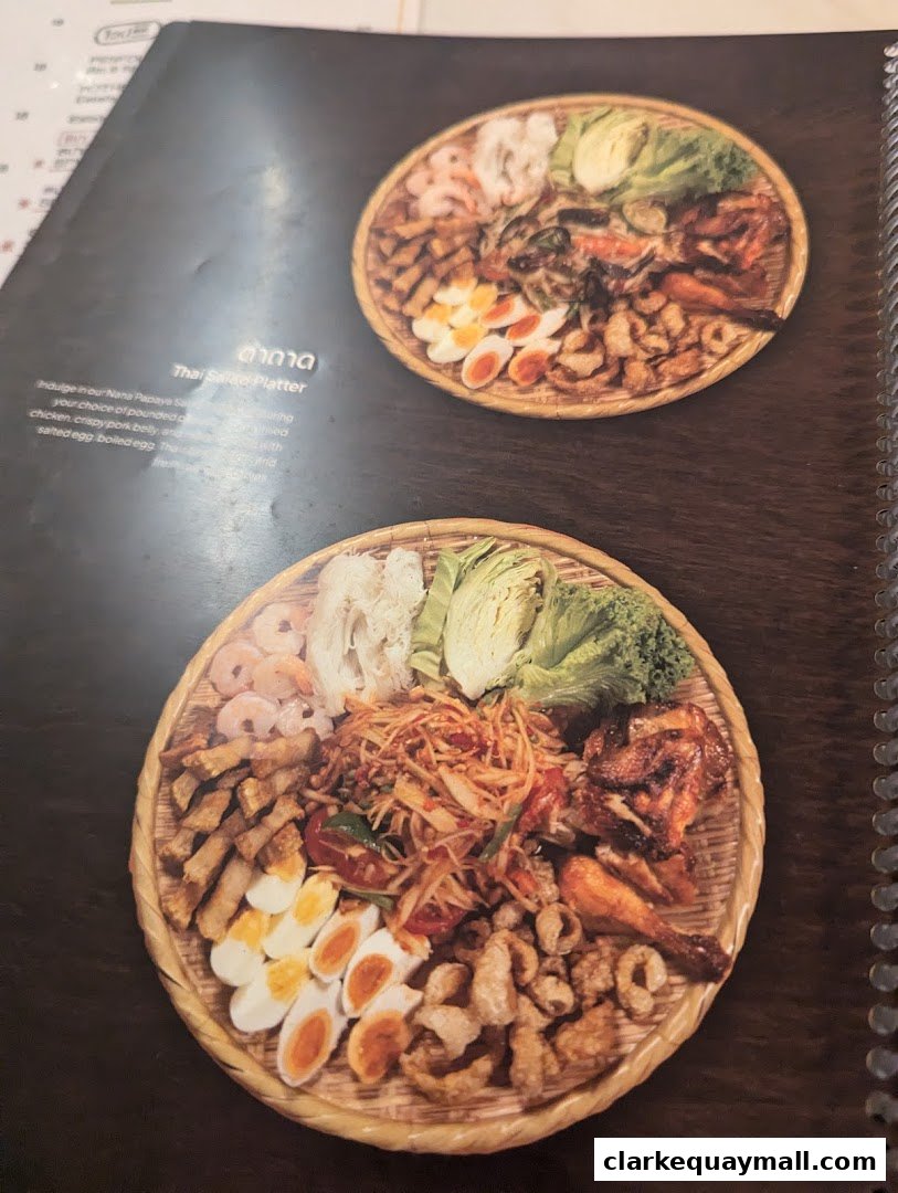 A menu page showcasing two Thai Salad Platters with various ingredients.