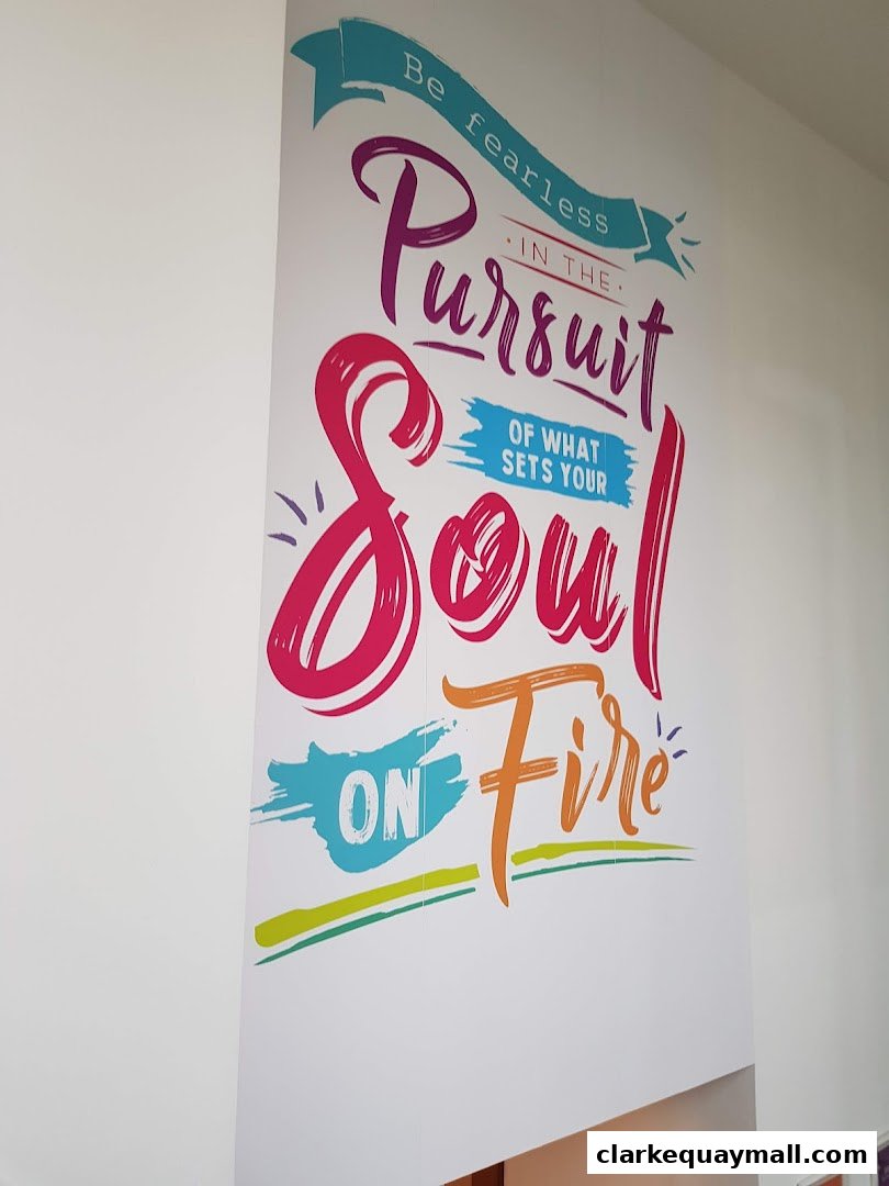 A wall with a motivational quote in colorful lettering.
