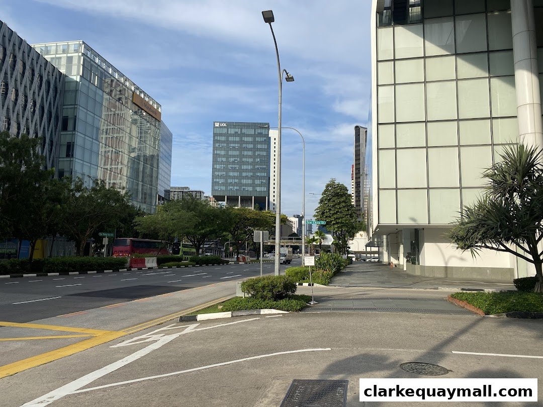 A street view of modern office buildings and a sidewalk on a sunny day.