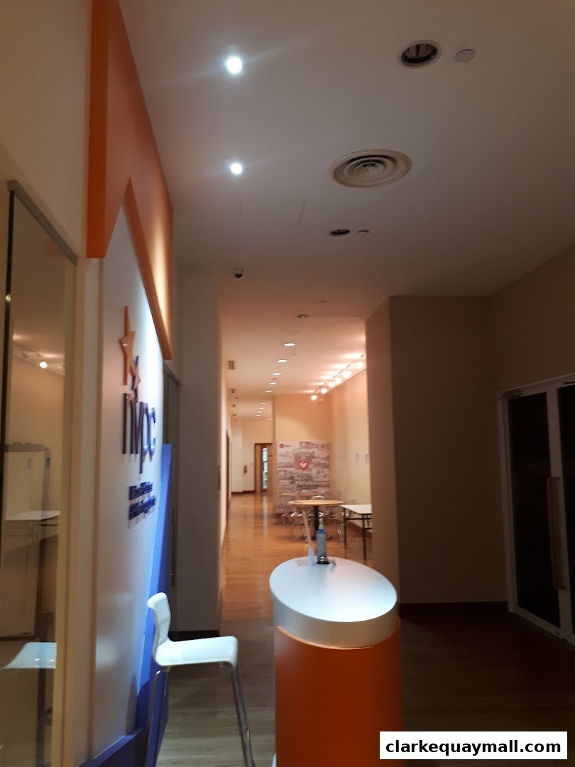 Interior hallway of the National Volunteer Philanthropy Centre with signage and seating.