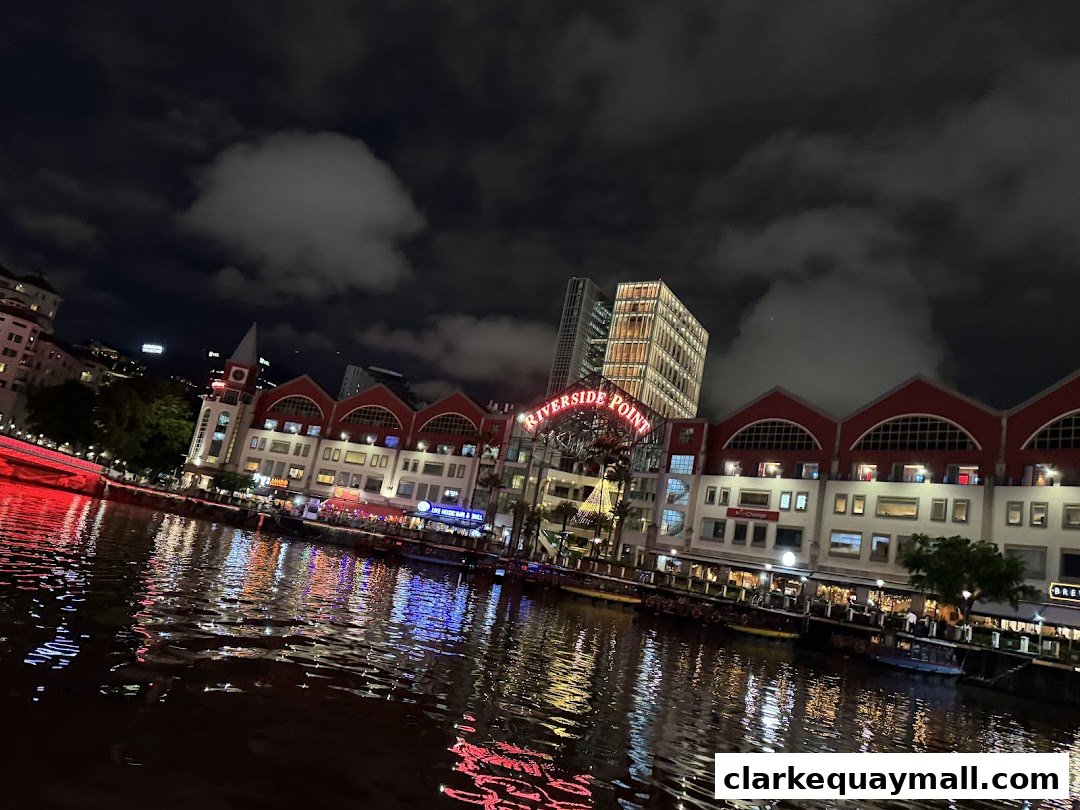 A nighttime view of Riverside Point buildings reflecting on the water.