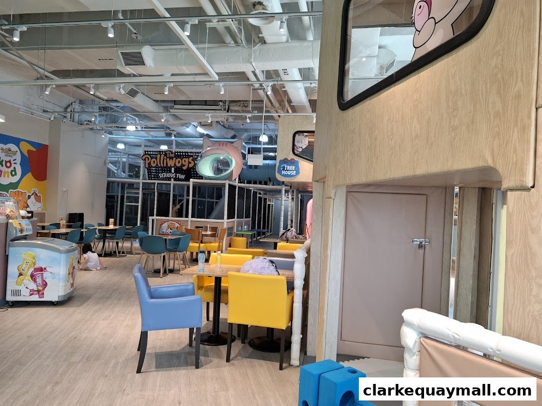 Interior of a colorful indoor playground with seating areas and play structures.
