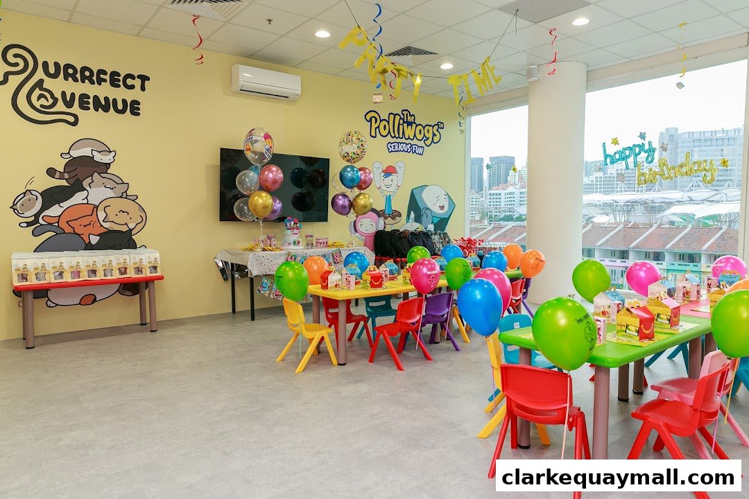 A brightly decorated party room with colorful balloons, tables, and chairs, featuring cartoon characters.