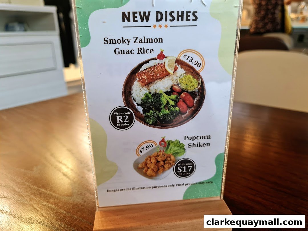 A menu display featuring two new dishes: Smoky Salmon Guac Rice and Popcorn Shiken.