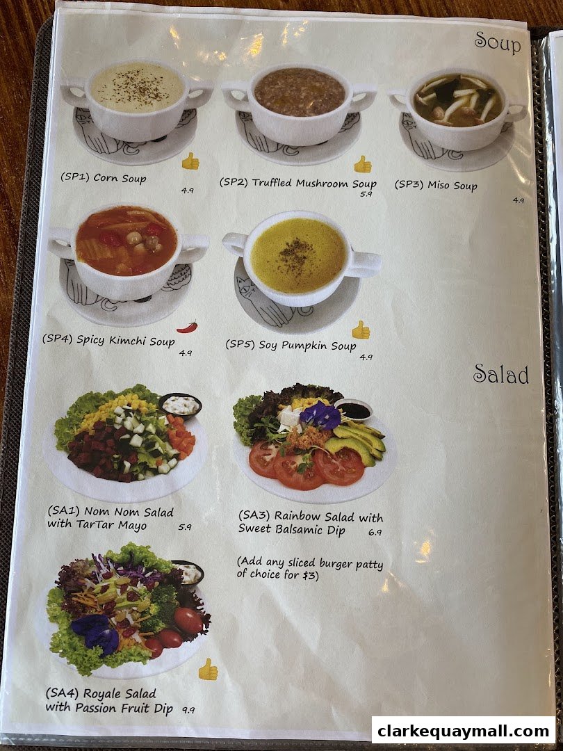 A menu page from nomVnom Bistro featuring soups and salads with prices.