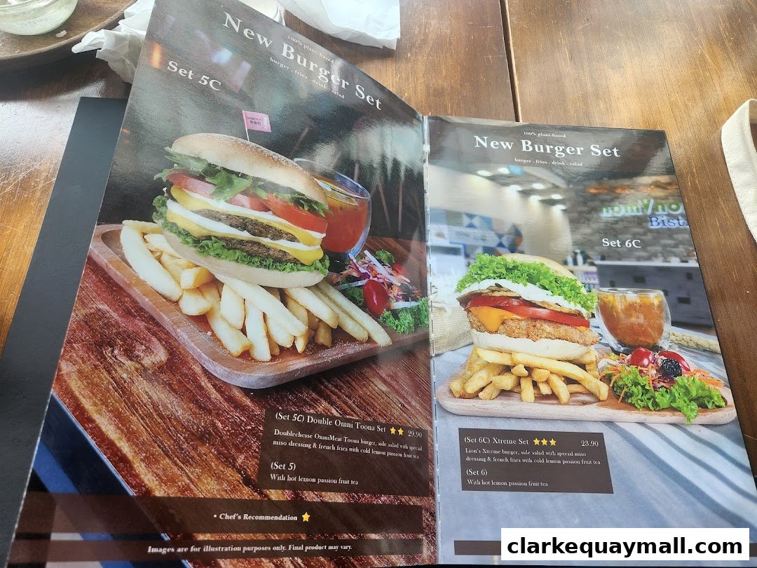 A menu from nomVnom Bistro featuring two plant-based burger sets with fries, salad, and drinks.