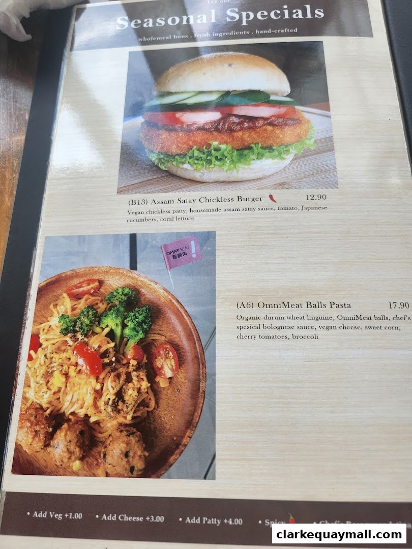 A menu page featuring a vegan burger and pasta dish with descriptions and prices.