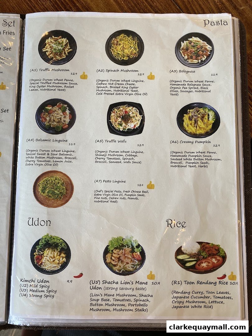 A menu page from nomVnom Bistro featuring pasta, udon, and rice dishes with enticing descriptions and prices.