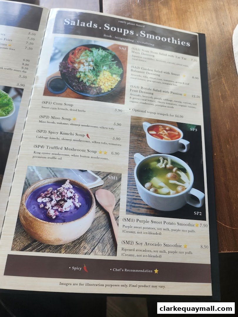 A menu page from nomVnom Bistro featuring salads, soups, and smoothies with enticing descriptions and prices.