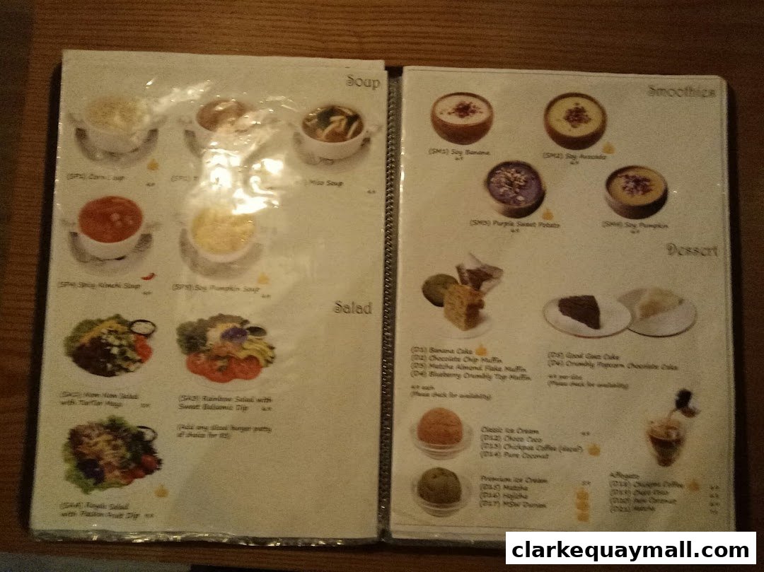A menu from nomVnom Bistro featuring soups, salads, smoothies, and desserts.