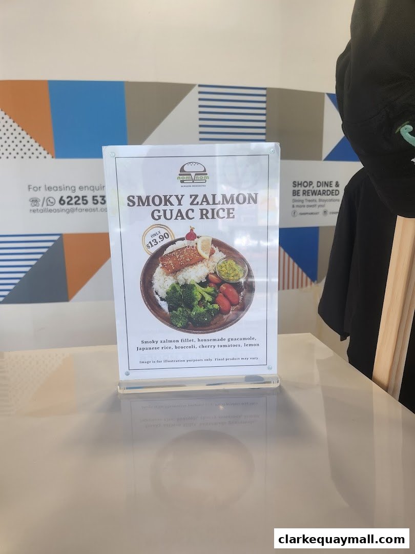 A menu display for "Smoky Salmon Guac Rice" at nomVnom Bistro.