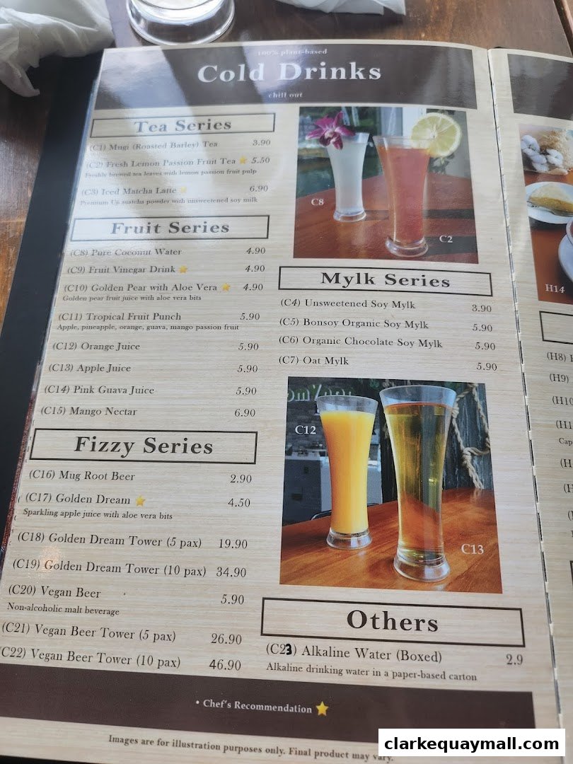 A menu from nomVnom Bistro featuring cold drinks, including tea, fruit, mylk, fizzy, and other beverages.