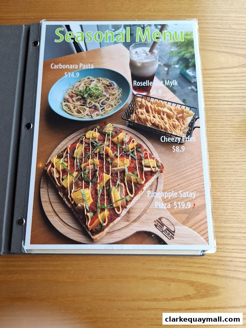 A seasonal menu from nomVnom Bistro featuring pasta, fries, pizza, and a drink.