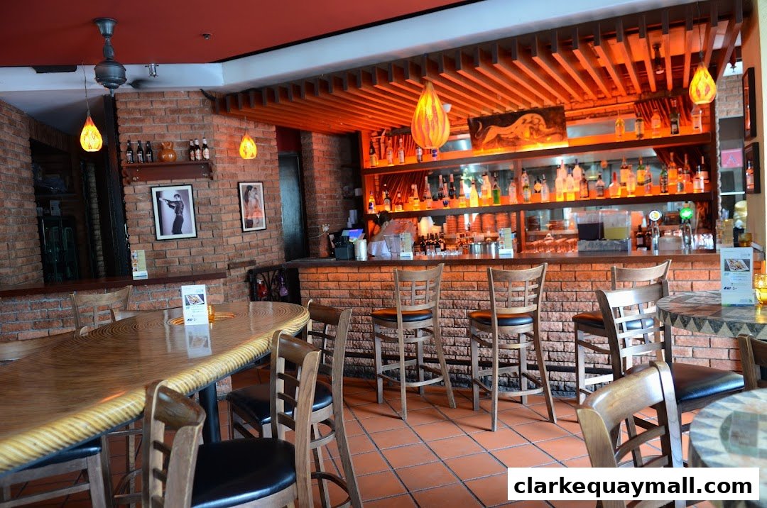 Interior of a tapas bar with a brick wall, bar, and seating.
