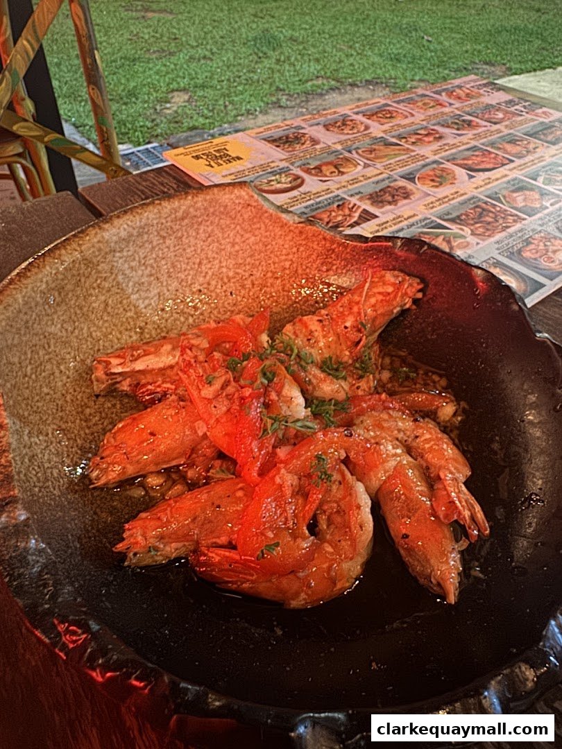 A close-up of a plate of succulent prawns, with a menu visible in the background.