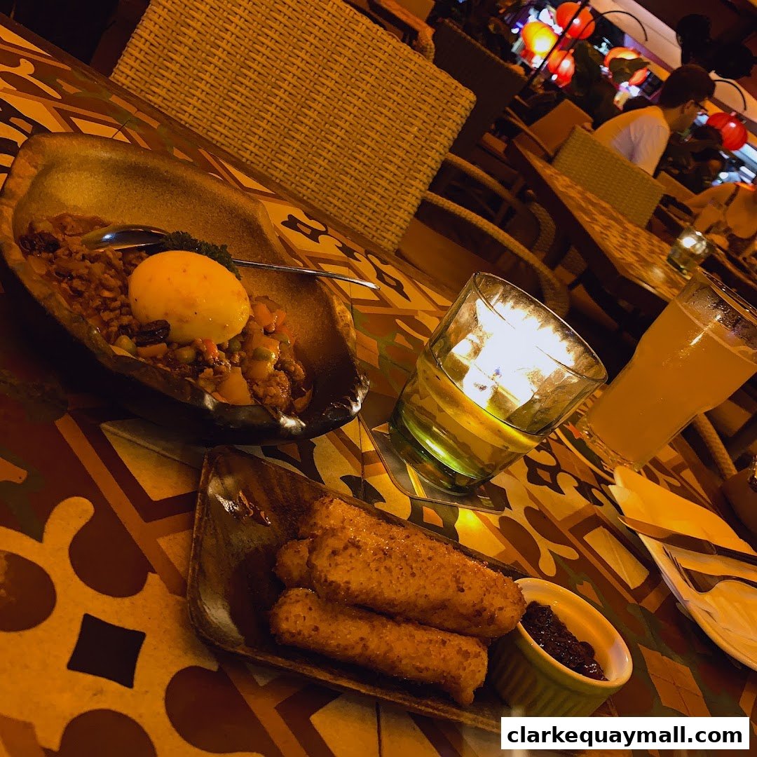 A table setting at Octapas with tapas, a drink, and a candle.
