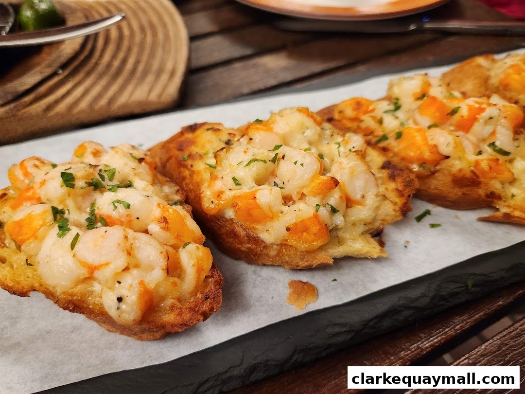 Close-up of delicious shrimp and cheese tapas on toasted bread, garnished with parsley.