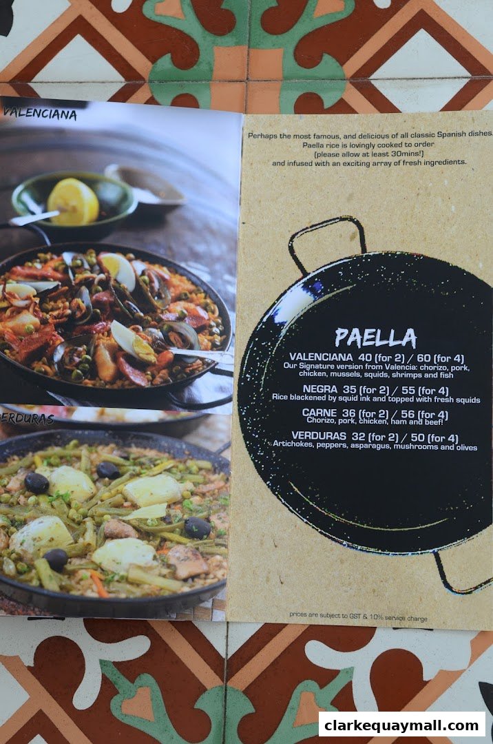 A menu featuring delicious paella dishes with vibrant images of the food.