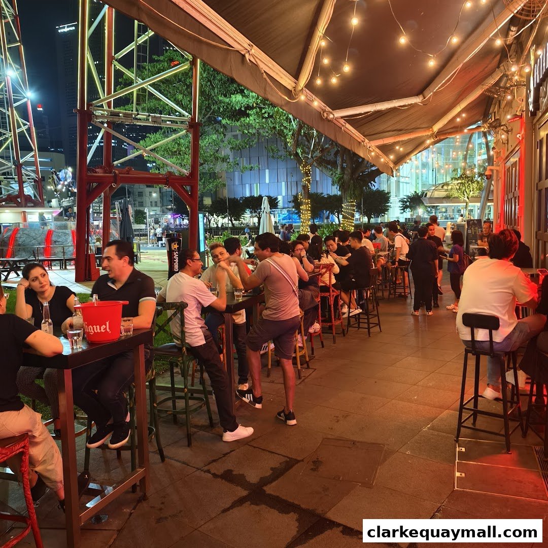 People enjoying tapas and drinks at an outdoor bar with string lights.