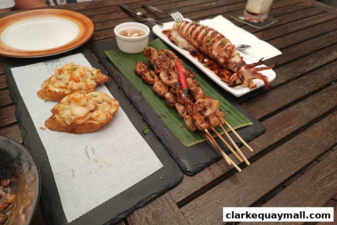 A table laden with various tapas dishes, including grilled squid, skewers, and bruschetta.