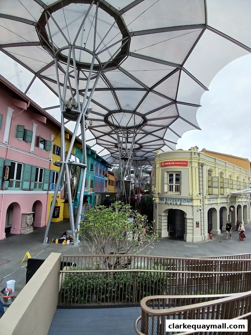 A vibrant street scene with colorful buildings and a modern canopy structure.