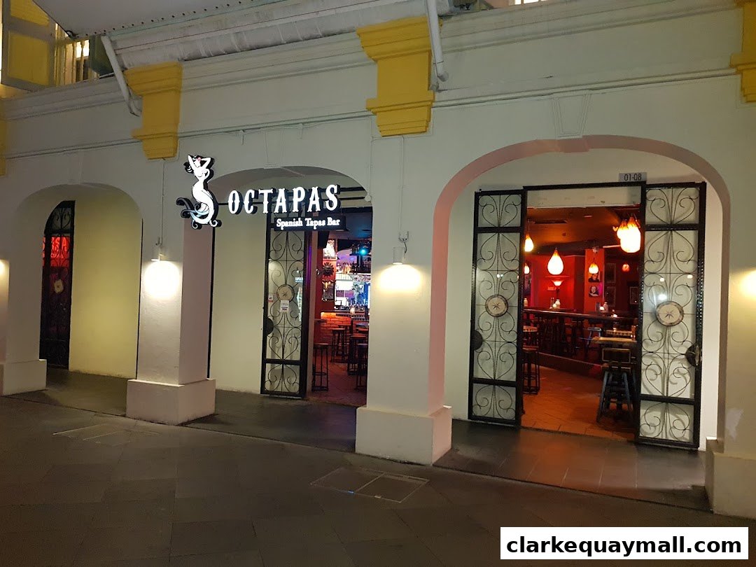 The entrance to Octapas, a Spanish Tapas Bar, with its inviting interior visible.