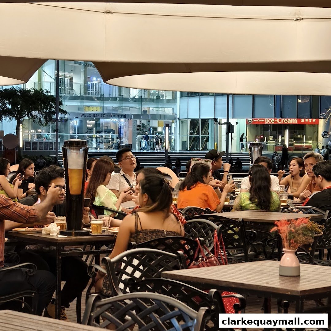 People dining and socializing at outdoor tables under a canopy.