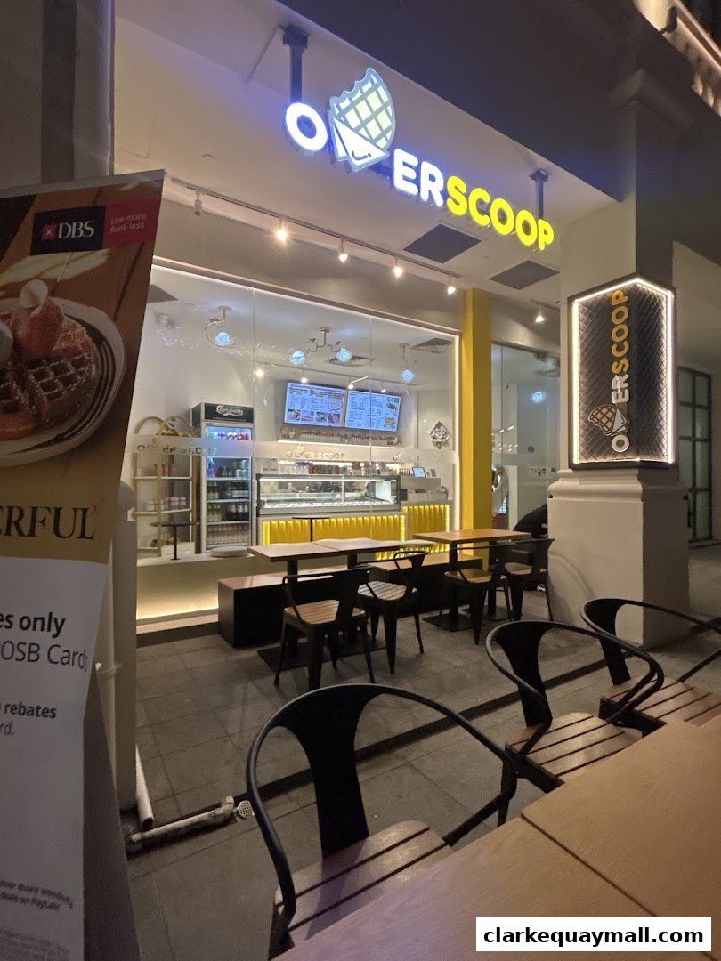 The exterior of Overscoop CQ Clarke Quay Freshly Made Waffles, with seating outside.