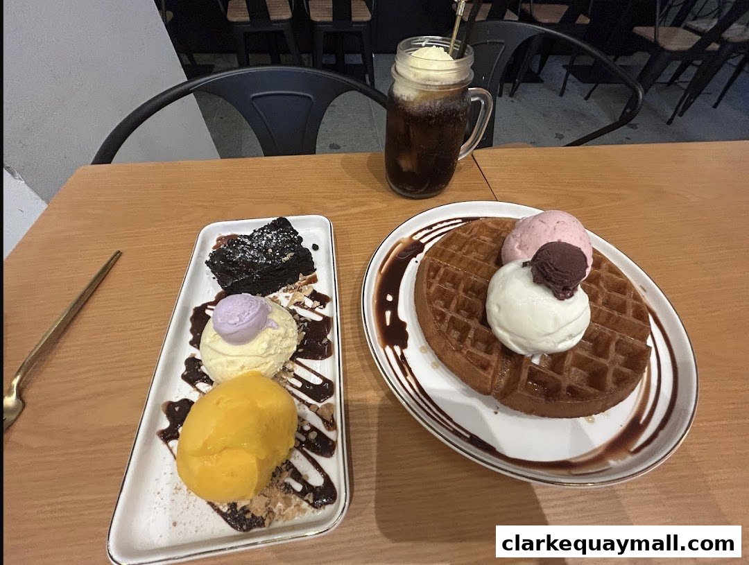 A table with a waffle, brownie, ice cream, and a drink.
