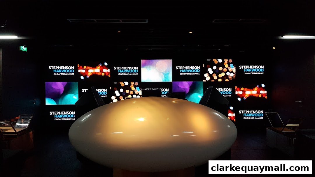 A modern interior with multiple screens displaying the Stephenson Harwood logo and abstract visuals.