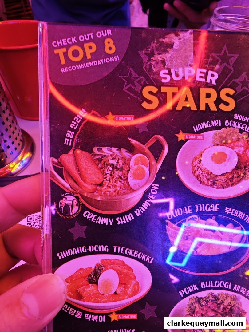 A menu featuring Korean street food recommendations with vibrant visuals and neon accents.