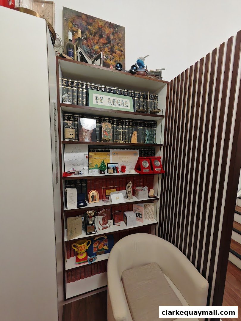A bookshelf filled with legal books, awards, and decorative items in an office setting.