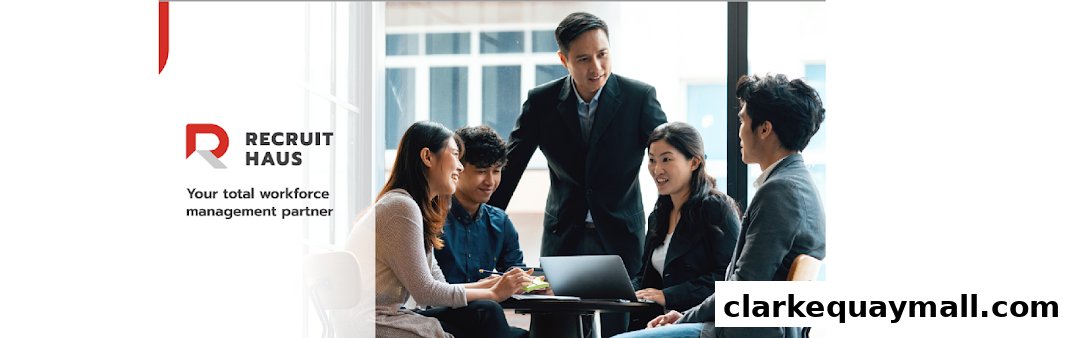 A team of professionals collaborating around a table with a laptop.