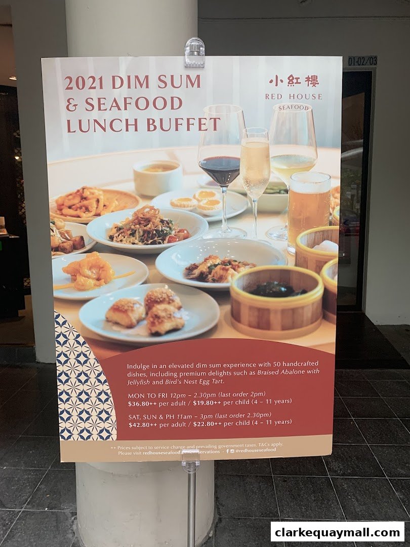 A sign advertising a dim sum and seafood lunch buffet with prices and operating hours.