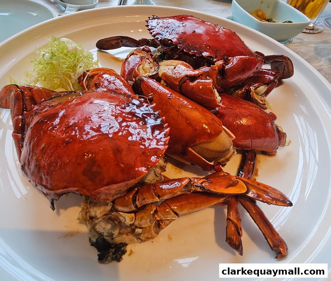 A close-up shot of a platter of delicious, glossy red crabs, garnished with a small salad.