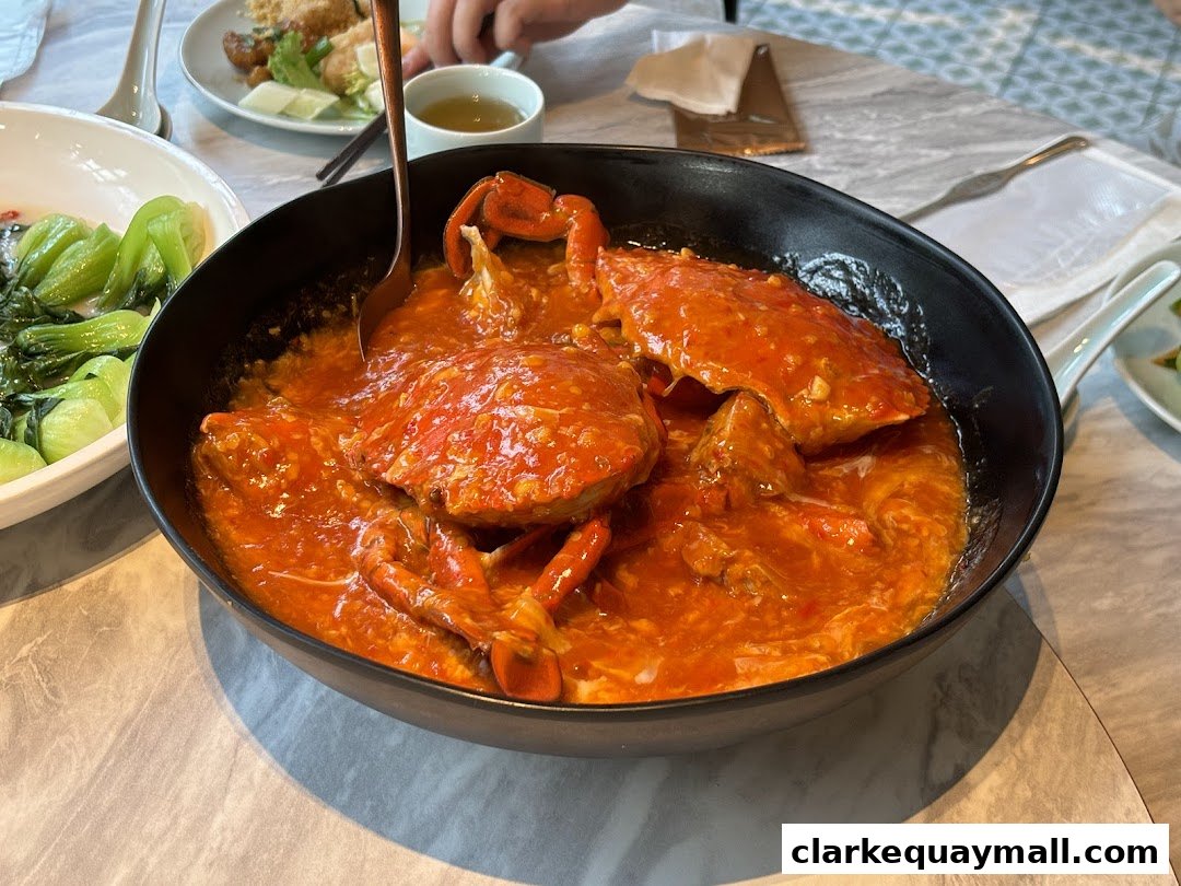 A close-up shot of a delicious seafood dish, likely chili crab, served in a black bowl.