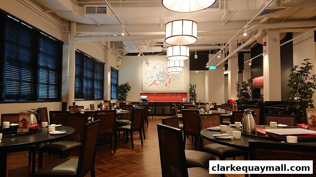 Interior view of a spacious restaurant with tables set for dining and modern lighting.