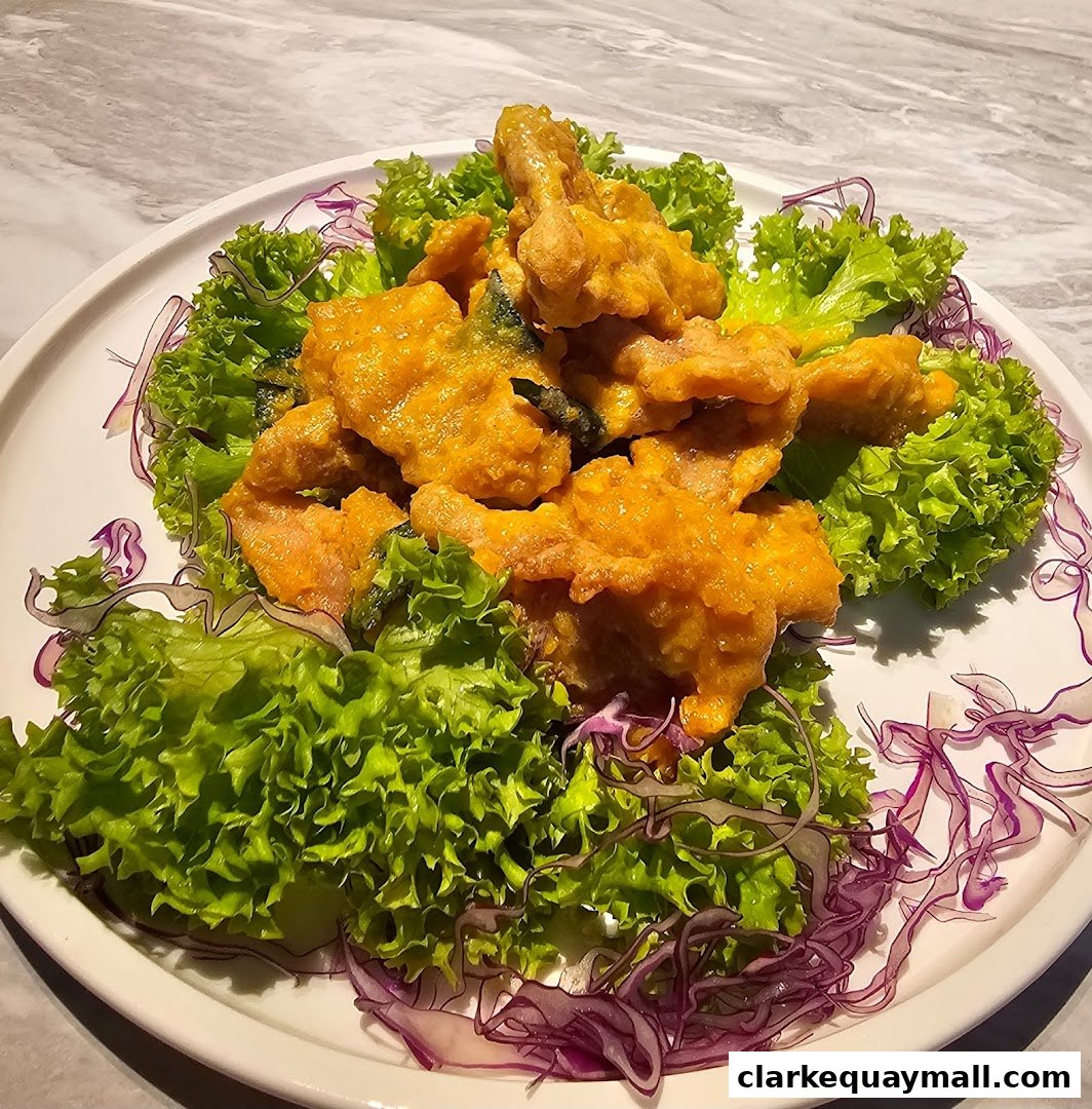 A plate of golden fried seafood, garnished with fresh lettuce and red cabbage.
