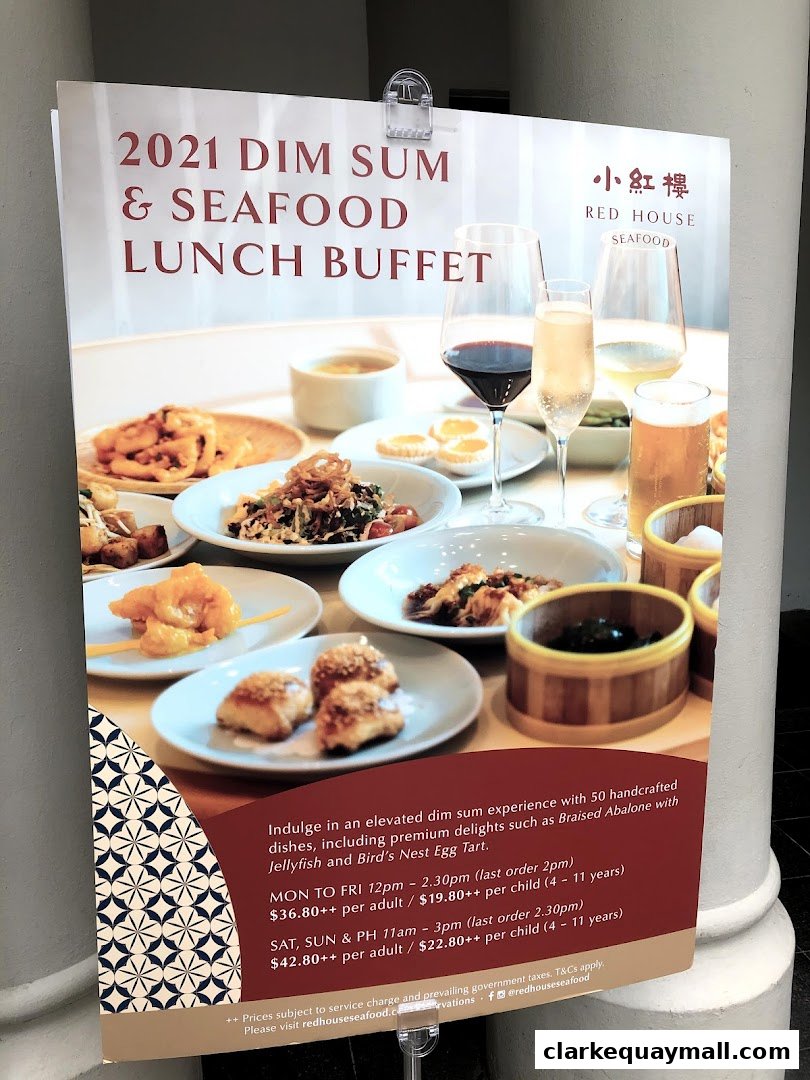 A sign advertising a 2021 Dim Sum & Seafood Lunch Buffet with prices and operating hours.