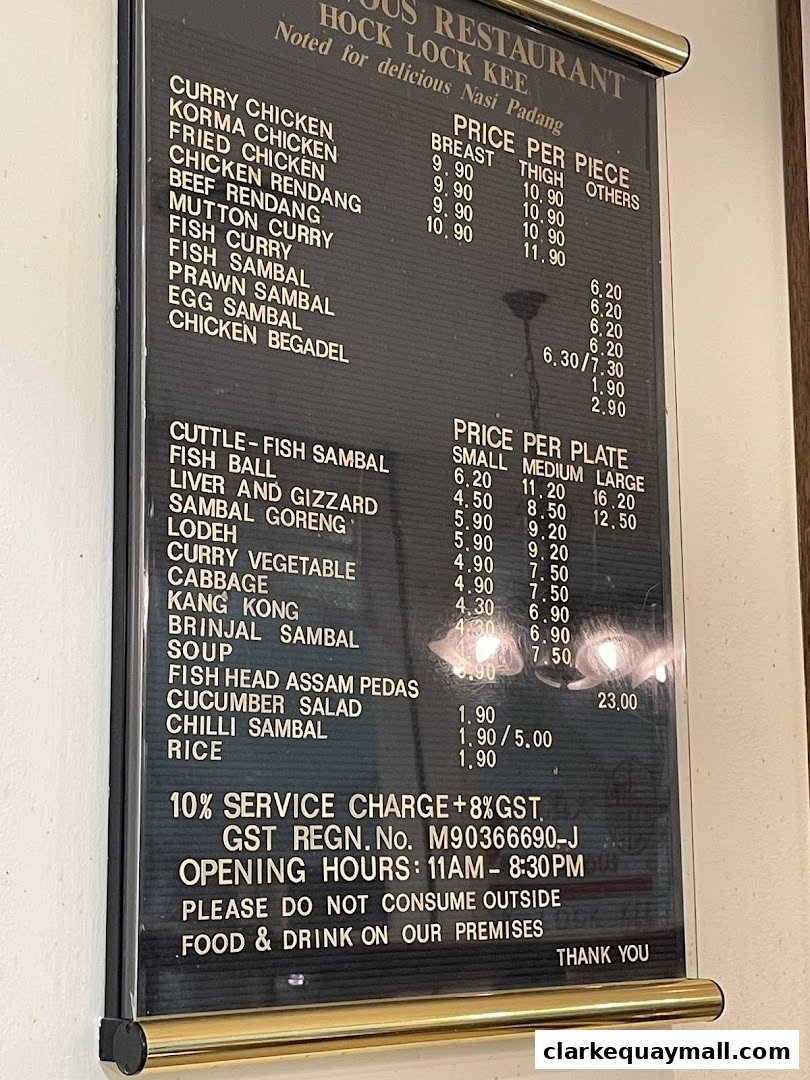 A black menu board with white text listing various dishes and prices for Hock Lock Kee Restaurant.